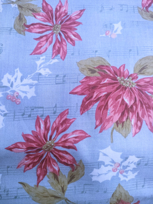 Flor de pascua y notas de música.